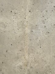 Close-up view of a concrete wall texture, showcasing its rough surface and industrial character. Ideal as a background for architecture, construction, or design projects needing a raw and urban.