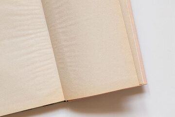Open book with yellowed blank pages on white background as template with place for text