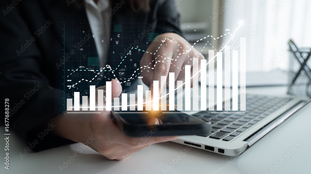 Aufkleber a business professional analyzes financial data on a smartphone and laptop while interpreting charts