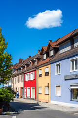 Colorful houses and fluffy cloud on a sunny street in Breisach am Rhein, Germany