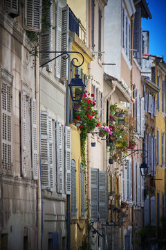 Vintage Marseille street with colorful shuttered windows and flower pots in historic Le&nbsp;Panier district on sunny day