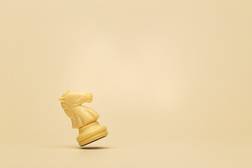 Single ivory chess knight piece standing on beige background, symbol of strategy, planning and tactical thinking © Antonio