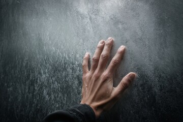 A hand presses against a wet, reflective surface, capturing the essence of moisture in a quiet, contemplative moment Generative AI