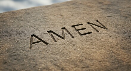 Carved amen word on stone surface stock image