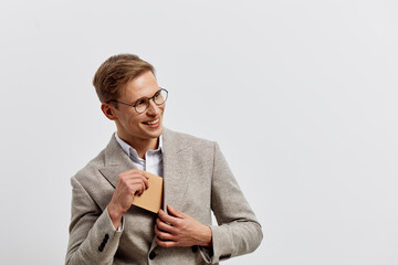 Smiling man wearing glasses and suit hold credit card use fintech digital banking concept isolated...