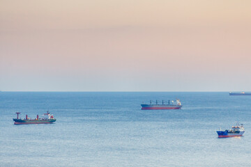 Port of Novorossiysk at sunset. Ships in port roadstead.