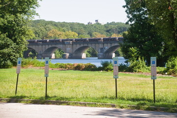 Hanicap parking in Fairmont park with a Train on the Railroad Bridge crossing the Schuylkill River...