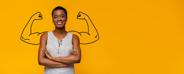 A young African American woman stands confidently with folded arms against a bright yellow backdrop...