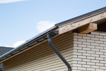 Modern guttering on a modern roof. Roof drainage.
