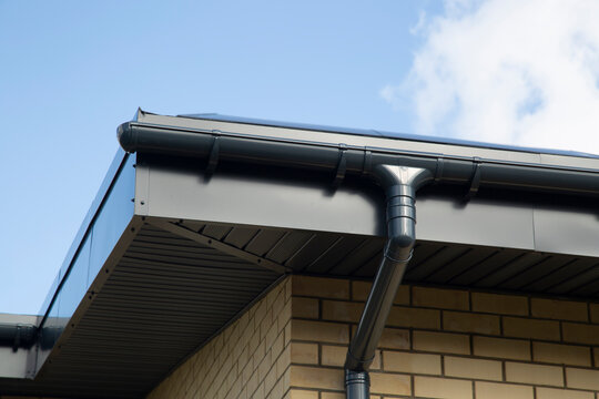 Modern guttering on a modern roof. Roof drainage.
