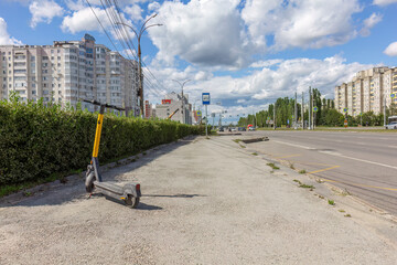 Quiet Urban Street with Abandoned Scooter