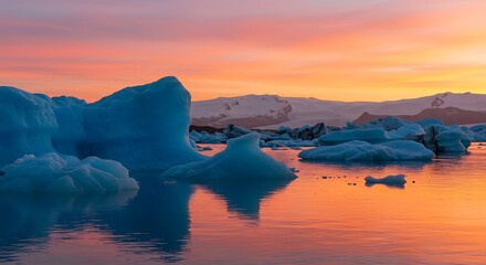 Icelandic glacier lagoon at sunset reflects blue icebergs and mountains in a breathtaking vista