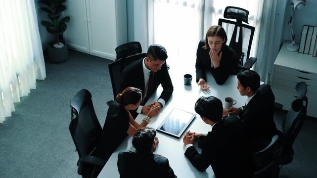 Top view of diverse business team discuss about marketing idea while businessman analyze financial graph from tablet at meeting room. Group of smart team brainstorm idea at conference. Directorate. - Powered by Adobe