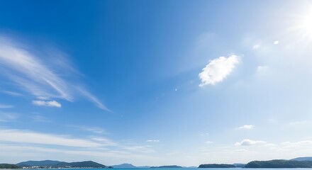 Fototapeta premium Vast Blue Sky with Wispy Clouds Over Calm Water.