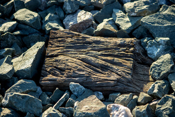 A piece of wood with crushed rock