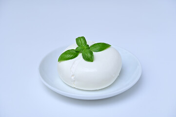 burrata cheese on a plate close-up on a white background