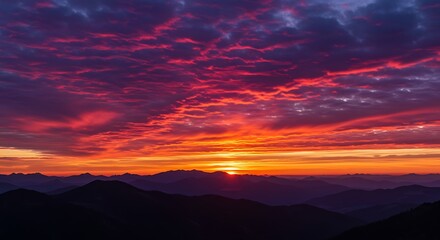 Majestic mountain range silhouettes beneath a vibrant twilight sky landscape scene