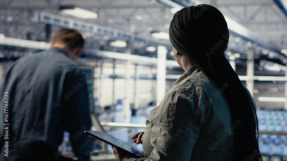 Poster data center employee monitoring infrastructure processes, reviewing operational metrics. server room
