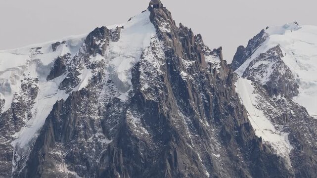 4k Aerial footage of Aiguille du Midi in the distance showing the scale of the french alps in detail