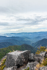 A vertical shot of a landscape background with rocks and paramo from the summit of Cerro Urán on a cold morning in Chirripo National Park, Costa Rica. © Saintdags
