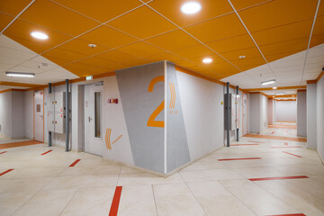Explore the essence of modern corridor design while incorporating vibrant orange accents