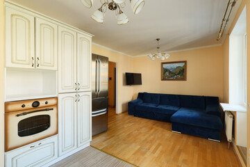 A Modern Kitchen and Living Room Combo Featuring a Cozy Couch for Ultimate Relaxation