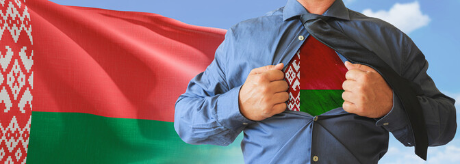 A businessman opening his shirt like super hero with Belarus flag and shows how patriotic he is by...