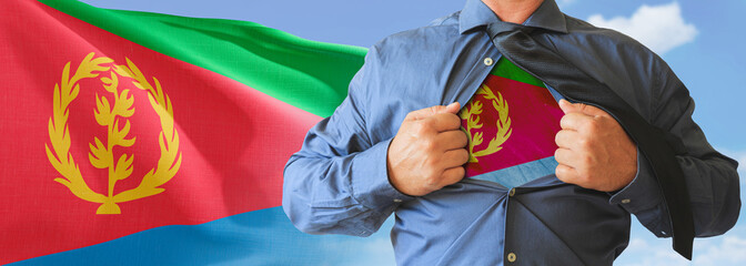 A businessman opening his shirt like super hero with Eritrea flag and shows how patriotic he is by...