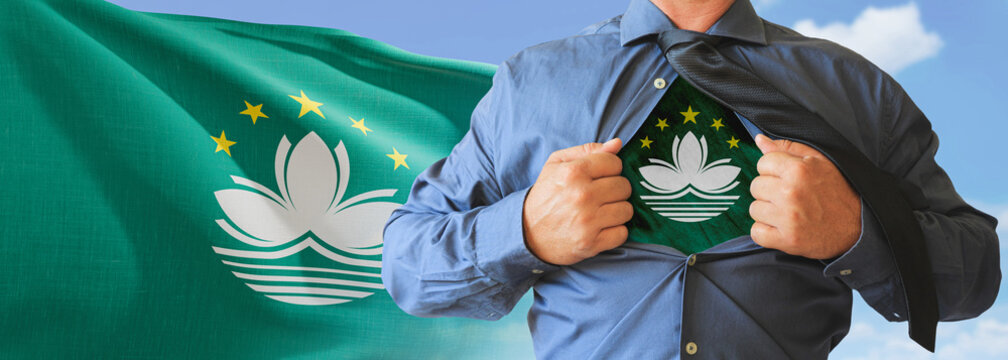 A businessman opening his shirt like super hero with Macau flag and shows how patriotic he is by revealing his countries flag beneath printed on a t-shirt. - Powered by Adobe