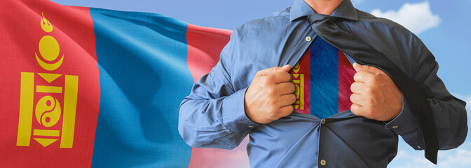 A businessman opening his shirt like super hero with Mongolia flag and shows how patriotic he is by...