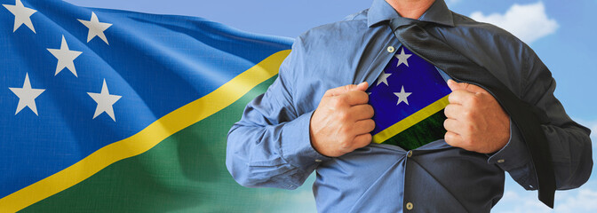 A businessman opening his shirt like super hero with Solomon Islands flag and shows how patriotic...