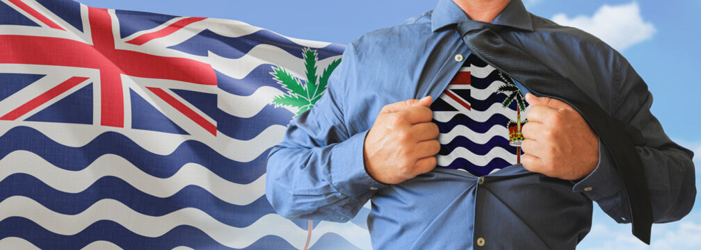 A businessman opening his shirt like super hero with British Indian Ocean flag and shows how patriotic he is by revealing his countries flag beneath printed on a t-shirt.