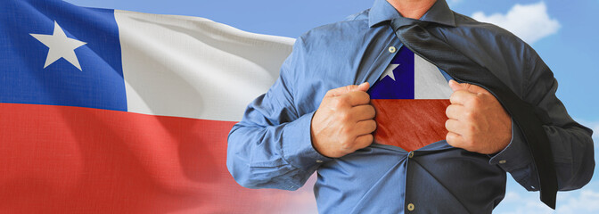 A businessman opening his shirt like super hero with Chile flag and shows how patriotic he is by...