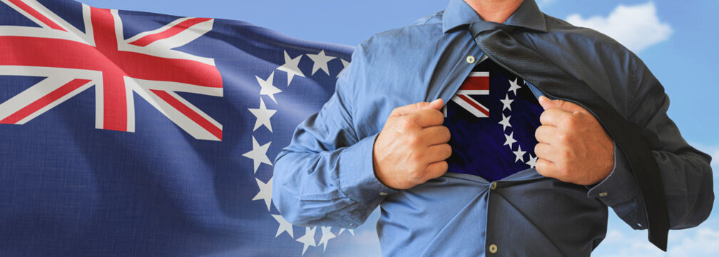 A businessman opening his shirt like super hero with Cook Island flag and shows how patriotic he is by revealing his countries flag beneath printed on a t-shirt.