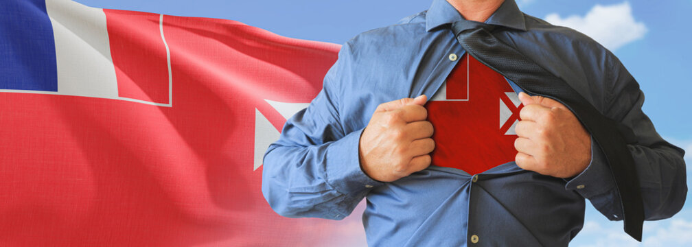 A businessman opening his shirt like super hero with Wallis and Futuna flag and shows how patriotic he is by revealing his countries flag beneath printed on a t-shirt.