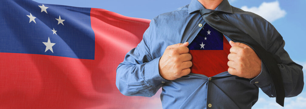 A businessman opening his shirt like super hero with Western Samoa flag and shows how patriotic he is by revealing his countries flag beneath printed on a t-shirt.