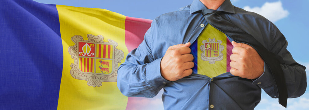 A businessman opening his shirt like super hero with Andorra flag and shows how patriotic he is by revealing his countries flag beneath printed on a t-shirt.