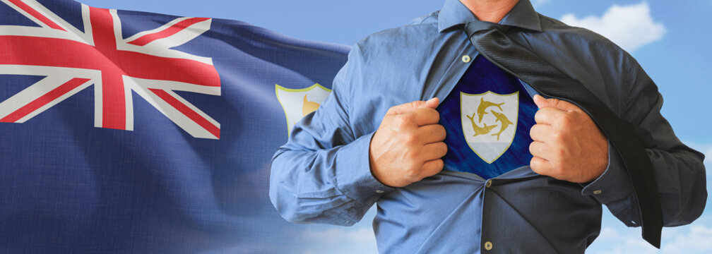 A businessman opening his shirt like super hero with Anguilla flag and shows how patriotic he is by revealing his countries flag beneath printed on a t-shirt.