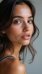 Fototapeta premium Stunning close-up portrait of a young woman with radiant skin
