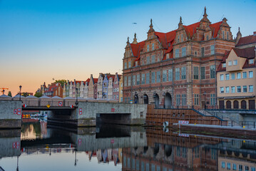 Waterfront with green gate in Gdansk during sunset, Poland
