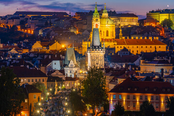 Obraz premium Sunset view of people passing Charles bridge towards Prague cast