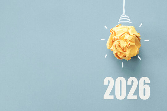 2026 with Yellow paper light bulb, business goal vision and new year resolution concept