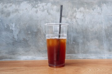 close-up of iced tea in a plastic cup with a straw