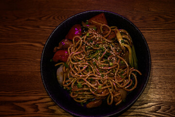 Japanese soba noodle with sesame seeds on a wooden table