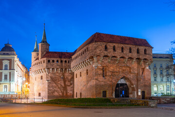 Fototapeta premium Night view of the Barbikan gate situated in the Polish city Krak