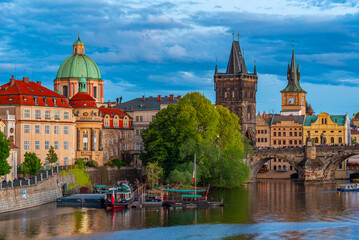 Obraz premium Sunset view of Charles bridge and Saint Salvator church in Pragu