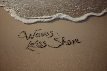 Fototapeta premium Waves Kiss Shore Phrase Written on Sand with Curling Wave