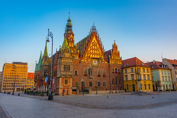 Fototapeta premium Sunrise view of town hall at Rynek, the picturesque square in ce