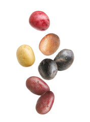 Different types of fresh potatoes falling on white background