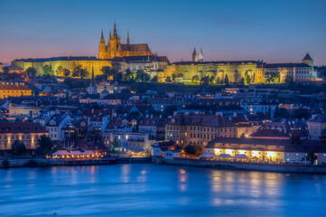 Fototapeta premium Sunset view of people passing Charles bridge towards Prague cast